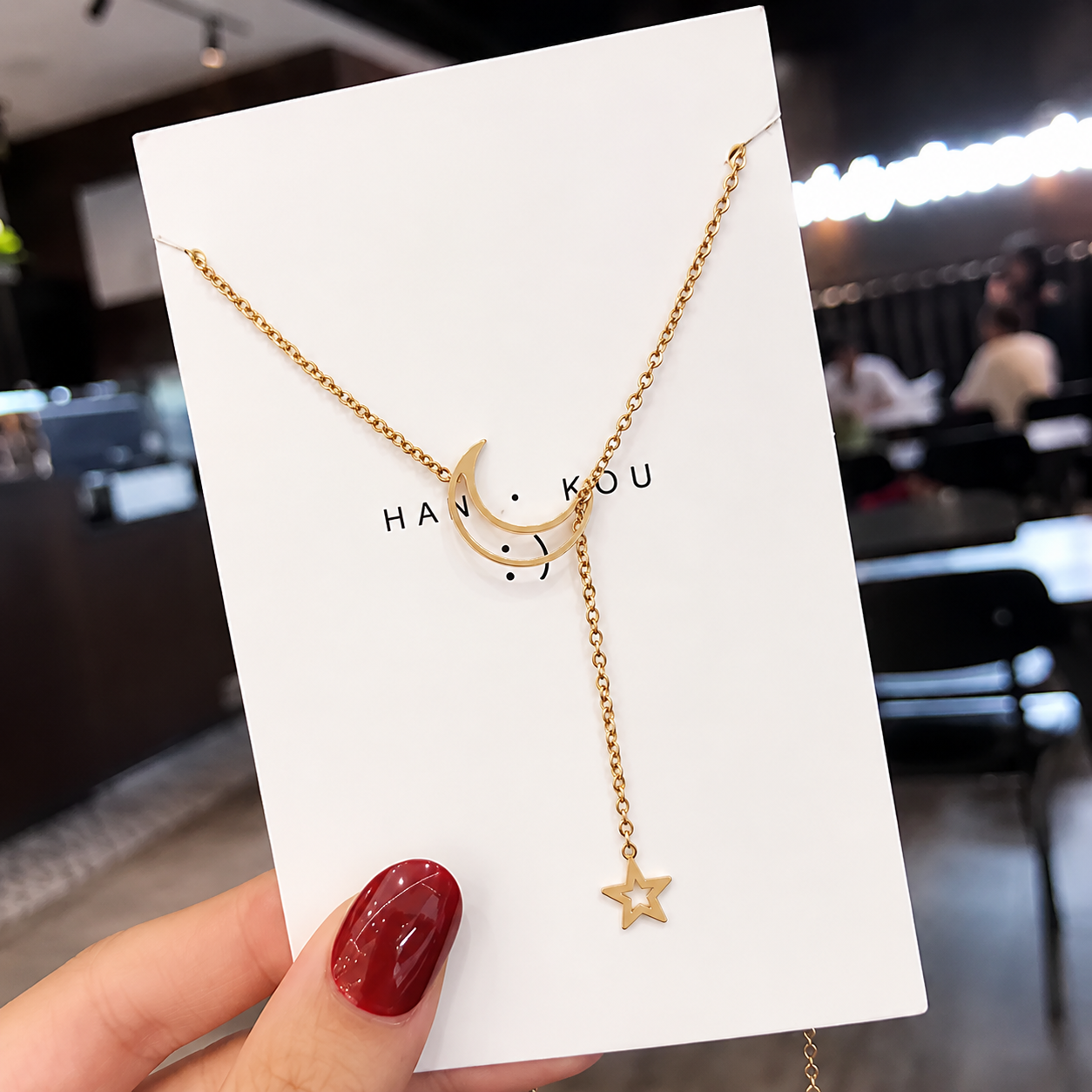 Moon and star necklace presented on a gift-ready display card