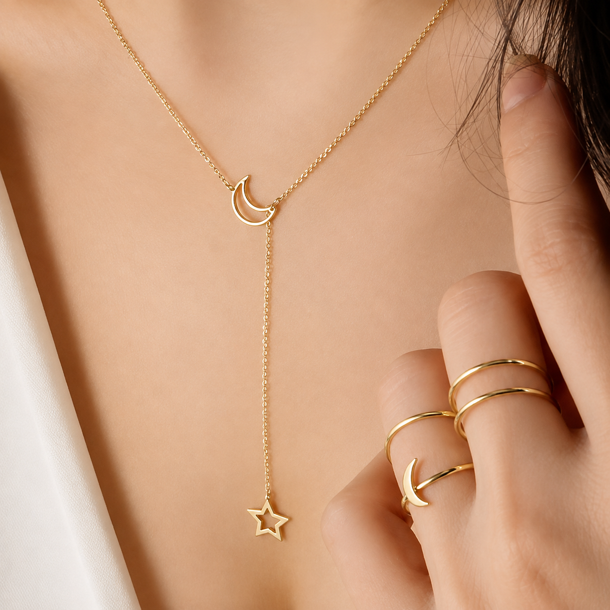 Close-up of the dainty gold crescent moon and star pendant chain on the neckline